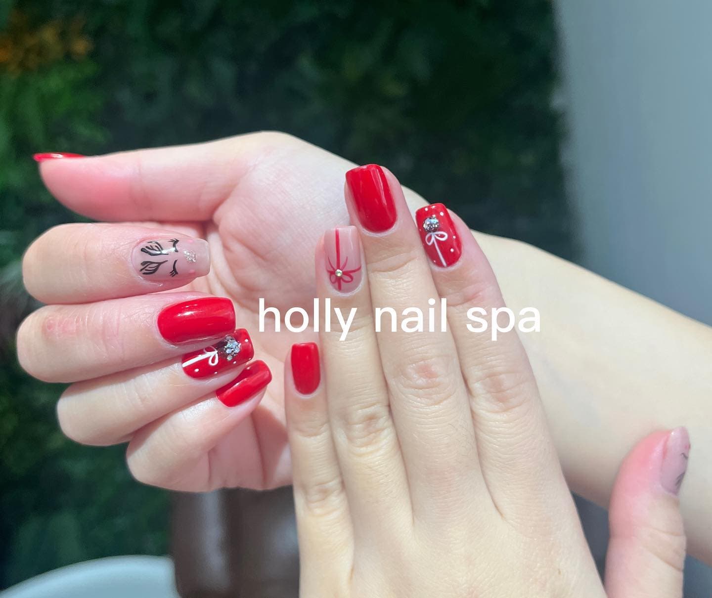 Unghie rosse con fiore di rosa e fiocco bianco con cristalli